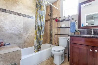 a bathroom with a toilet and a tub and a sink at Amazing BBQ POOl home at center of LA\u7f8e\u5f0f\u56db\u623f\u5927\u5730\u6cf3\u6c60\u70e7\u70e4\u533a\u7f8e\u5c4b in Chino Hills