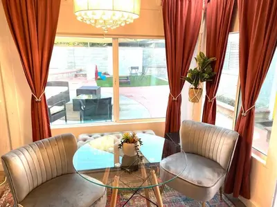 a dining room with a glass table and two chairs at Garden Suite - 10 mins to Beach and LAX in Gardena