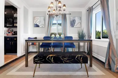 a dining room table with blue chairs and a chandelier at Luxury Home - 7mins LAX/Beach, 405/SoFi nearby in Hawthorne