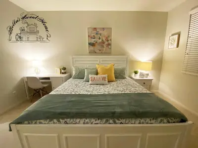 a bedroom with a large bed with yellow pillows at Bella's sweet house 11155 in Mira Loma