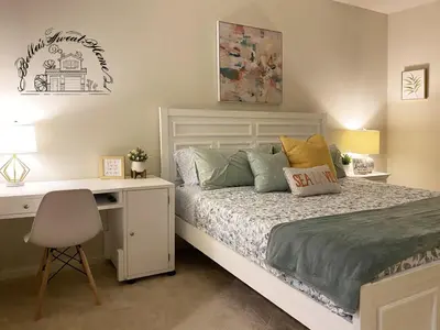 a bedroom with a bed with a desk and a bed sidx sidx sidx at Bella's sweet house 11155 in Mira Loma