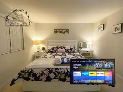 a bedroom with a bed with a computer monitor on it at Bella's sweet house 11155 in Mira Loma