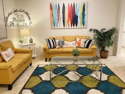 a living room with a couch and a glass table at Bella's sweet house 11155 in Mira Loma