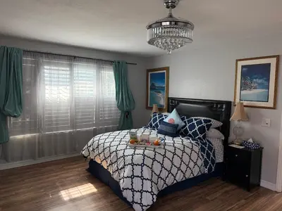 a bedroom with a bed with a tray of fruit on it at Romantic Coastal Private Room in Oxnard