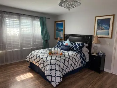 a bedroom with a bed with a tray of fruit on it at Romantic Coastal Private Room in Oxnard