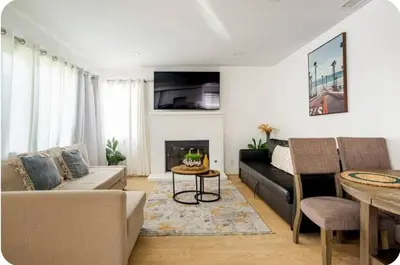 a living room with a couch and a fireplace at The Heart Of LA House in Los Angeles