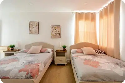 a bedroom with two beds and a window at The Heart Of LA House in Los Angeles