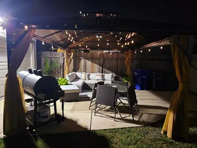 a patio with a couch and a table and chairs at The Heart Of LA House in Los Angeles
