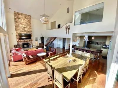 a living room with a couch and a table at Modern 6 bedroom retreat, stunning lake views, close to village! in Lake Arrowhead