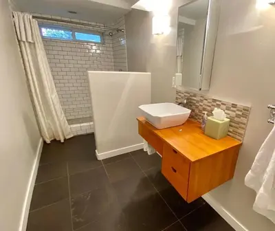 a bathroom with a sink and a mirror at Modern 6 bedroom retreat, stunning lake views, close to village! in Lake Arrowhead