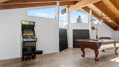 a ping pong table in a room with a pool table at Honeypot by AvantStay Indoor Pool Hot Tub in Big Bear Lake