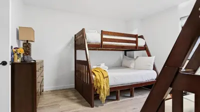 a bedroom with two bunk beds and a desk at Honeypot by AvantStay Indoor Pool Hot Tub in Big Bear Lake