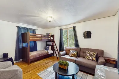 a living room with a couch and a bunk bed at Vintage Village Walk Cottage in Lake Arrowhead