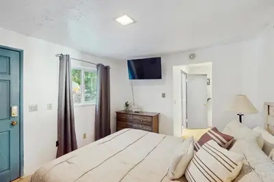 a bedroom with a bed and a couch at Vintage Village Walk Cottage in Lake Arrowhead