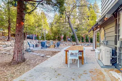a table and chairs sitting outside of a house at Saint Bernard Beauty in Lake Arrowhead