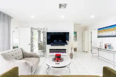 a living room with a couch and a table at New luxury entertaining house with Pool Spa Sauna Tesla charger Pets in Los Angeles