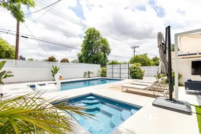 a swimming pool with a swan in a backyard at New luxury entertaining house with Pool Spa Sauna Tesla charger Pets in Los Angeles