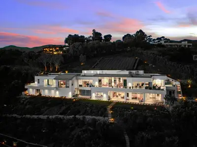 a large white house on a hill at night at Winding Way in Malibu