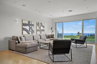 a living room with a couch and a table and chairs at Winding Way in Malibu