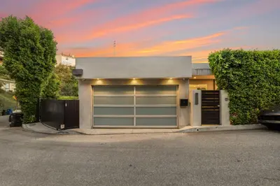 a house with two garage doors on a street at Sunset Heights in Los Angeles