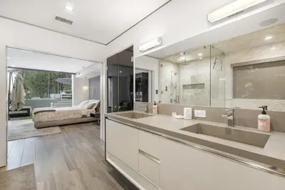 a bathroom with a sink and a large mirror at Sunset Heights in Los Angeles