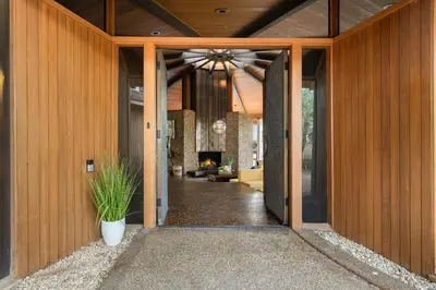 an open door of a house with a potted plant at Via Vallarta in Los Angeles