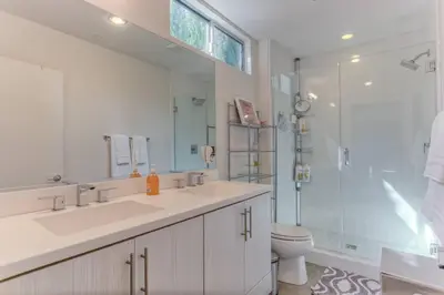 a bathroom with a sink and a shower and a toilet at Chic Silver Lake Oasis with Breathtaking City Skyline Views, Private Rooftop & Garage in Los Angeles