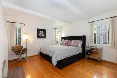 a bedroom with a bed and a chair in it at Renovated Spanish 3BD 2BA near Beverly Hills in Los Angeles