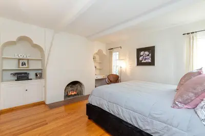 a bedroom with a bed and a fireplace at Renovated Spanish 3BD 2BA near Beverly Hills in Los Angeles