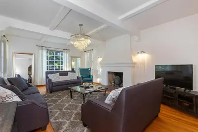 a living room with a couch and a tv at Renovated Spanish 3BD 2BA near Beverly Hills in Los Angeles