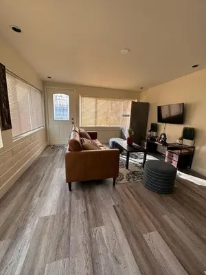 a living room with a couch and a table at Charming private guest Suite near Disney/Beach in Westminster