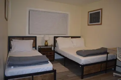 two beds sitting in a room with a window at Charming private guest Suite near Disney/Beach in Westminster