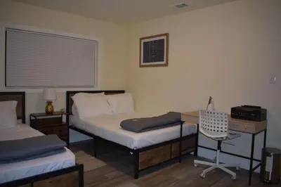 a bedroom with two beds and a desk and a chair at Charming private guest Suite near Disney/Beach in Westminster