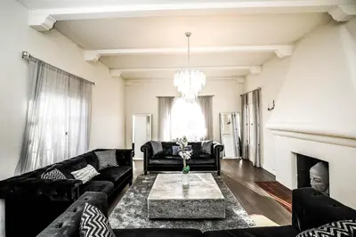 a living room with black furniture and a fireplace at Gorgeous Renovated 3BD 2BA near West Hollywood and Beverly Hills in Los Angeles