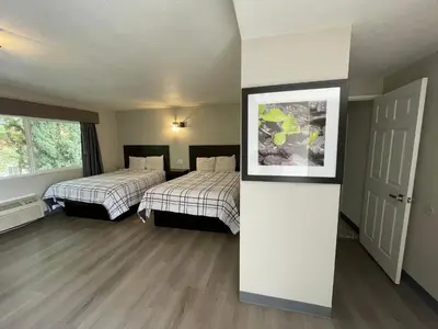 a room with two beds and a picture on the wall at Villa Inn Anaheim in Anaheim