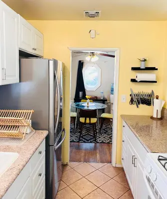 a kitchen with a stainless steel refrigerator and a table at Los Angeles Home Located in Beautiful Pasadena in Pasadena