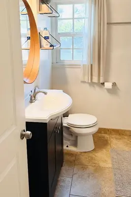 a bathroom with a toilet and a sink and a mirror at Los Angeles Home Located in Beautiful Pasadena in Pasadena
