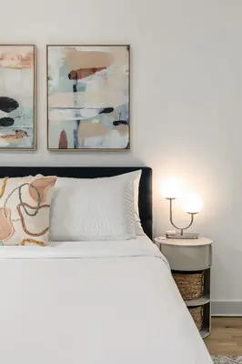a bedroom with a white bed and three paintings at Central Apartment in a Hip Walkable Neighborhood NRP23-01143 in Long Beach