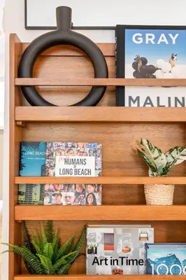 a wooden book shelf with books and magazines at Central Apartment in a Hip Walkable Neighborhood NRP23-01143 in Long Beach