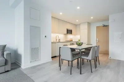 a kitchen and dining room with a table and chairs at Level Long Beach - East Village in Long Beach