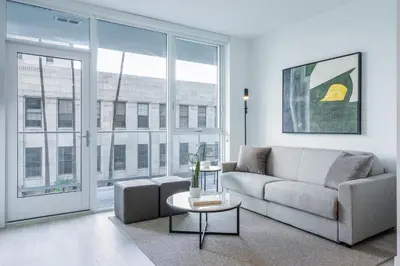 a living room with a couch and a table at Level Long Beach - East Village in Long Beach