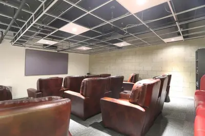 a conference room with leather chairs and a screen at Downtown 1BR w Pool Gym WD nr Staples Center LAX-551 in Los Angeles