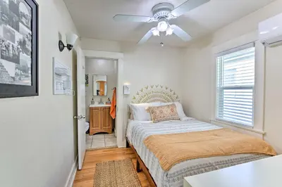 a bedroom with a bed and a ceiling fan at 7 Mi to Downtown Long Beach Bungalow with Patio! in Long Beach