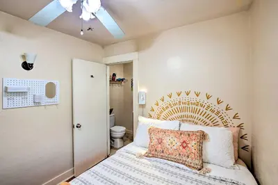a bedroom with a bed with a wooden headboard at 7 Mi to Downtown Long Beach Bungalow with Patio! in Long Beach
