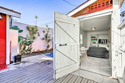 an open door to a backyard with a house at 7 Mi to Downtown Long Beach Bungalow with Patio! in Long Beach