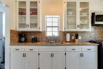 a kitchen with white cabinets and a sink at San Fernando Pool home + Large Private Guest House in San Fernando