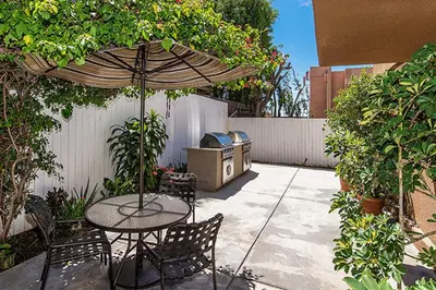 a patio with a table and chairs and an umbrella at Hollywood 1BR w Gym Spa Pool nr Metro LAX-52 in Los Angeles