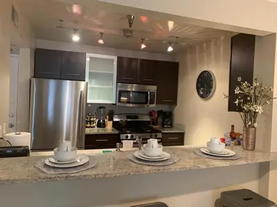 a kitchen with a stainless steel refrigerator and a counter at Hollywood loft spectacular free parking in Los Angeles