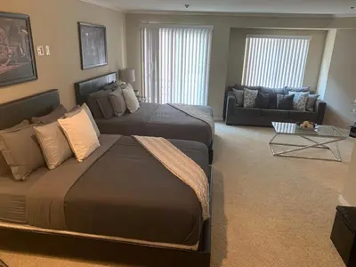 a bedroom with two beds and a living room at Hollywood loft spectacular free parking in Los Angeles
