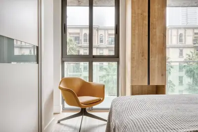 a bedroom with a chair in front of a window at Downtown 1BR w Pool Gym WD nr Staples Center LAX-547 in Los Angeles
